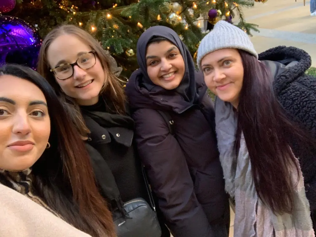 Selfie of four colleagues at Winter Wonderland in Hyde Park, London.